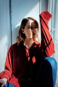 Sad woman sitting near window and shadows